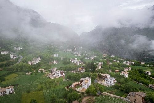 Tibetan Village on Danba Zhonglu surrounded by clouds and mist