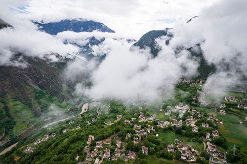 Tibetan Village on Danba Zhonglu surrounded by clouds and mist